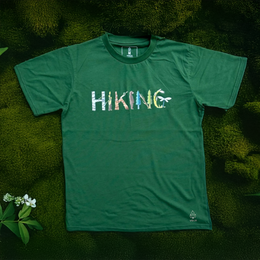 Flatlay of the Adventure in Letters Tee by VELU, an organic cotton hiking t-shirt designed for eco-friendly fashion and sustainability.