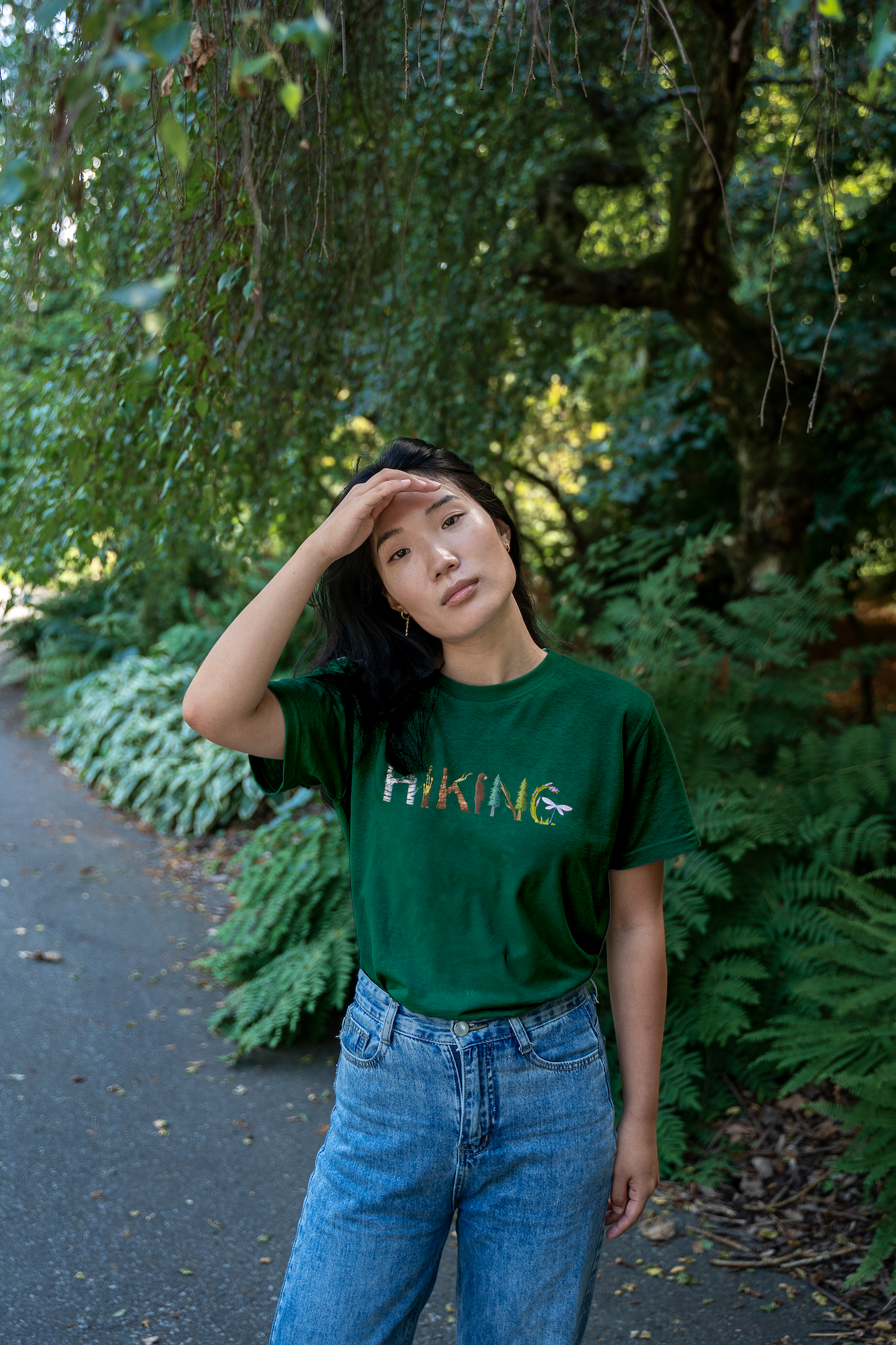 Model wearing the Adventure in Letters Tee by VELU for women, crafted from organic cotton for a breathable and eco-friendly fit during outdoor adventures.
