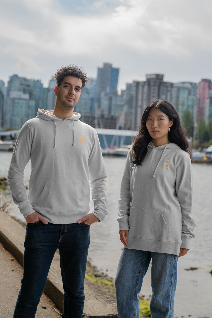 Eco-friendly unisex hoodies by VELU, featuring sustainable design with Vancouver skyline background.