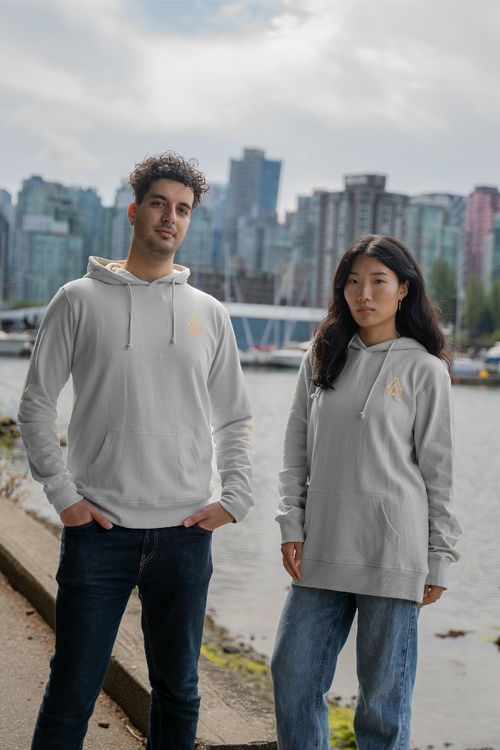 Models wearing the Vancouver Landmarks Hoodie by VELU, a sustainable and eco-friendly unisex hoodie, with a Vancouver cityscape backdrop.