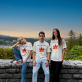 Three people wearing Maple Leaf Apparel t-shirts with a scenic background